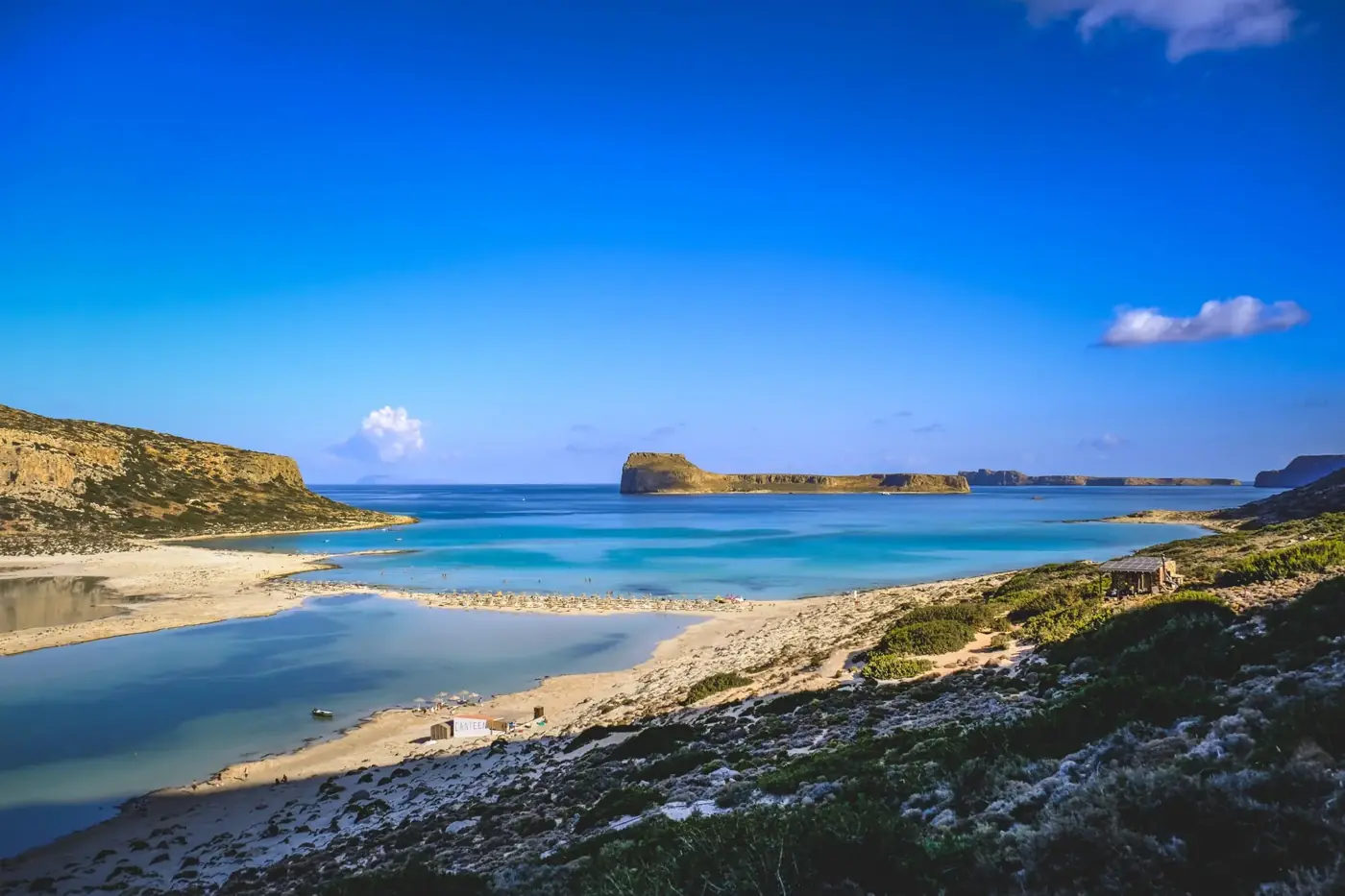 Breathtaking view of Balos Beach with turquoise waters and clear skies, perfect for travel enthusiasts.