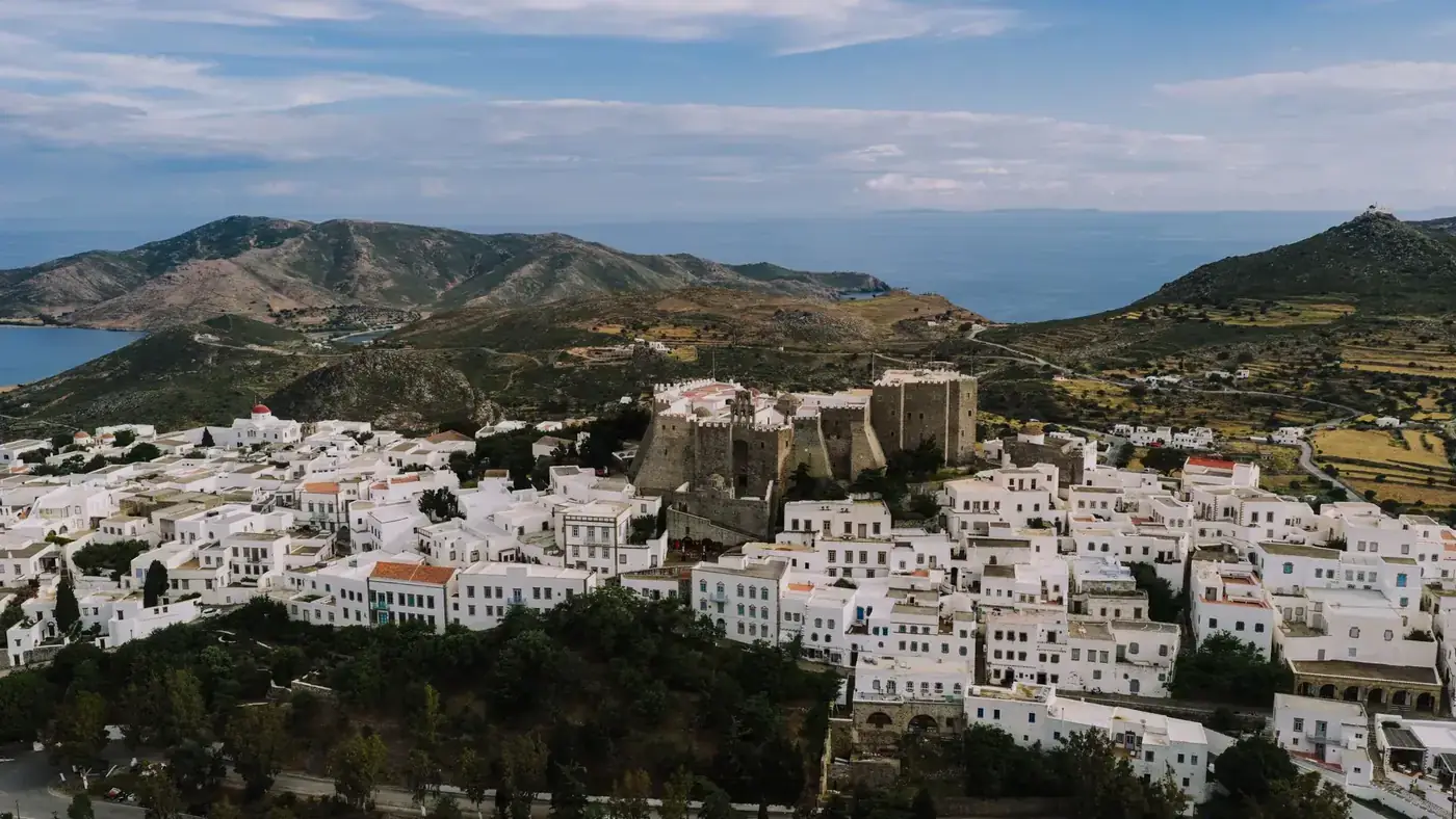 A stunning aerial capture of Patmos, Greece, showcasing traditional white buildings and historical landmarks.