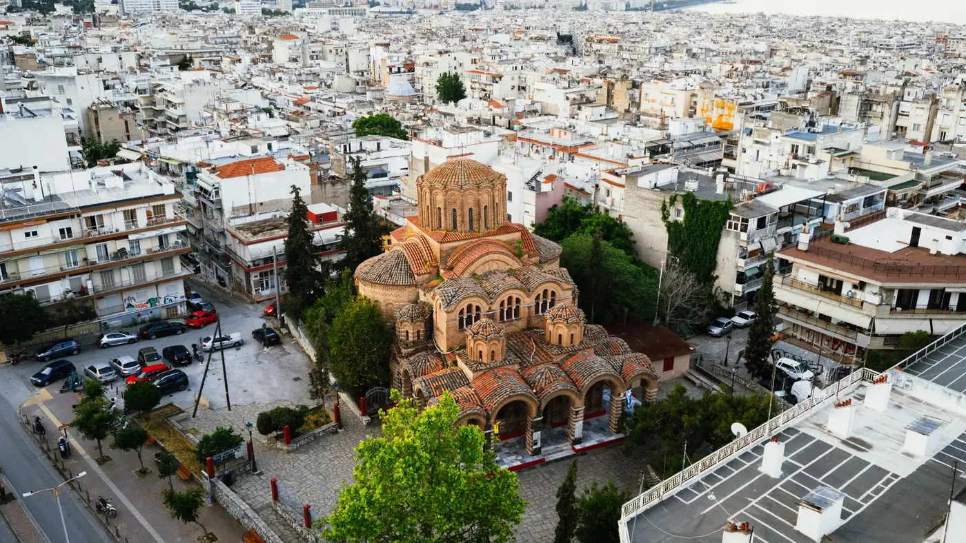 Capture of a Byzantine church in Thessaloniki, Greece from above, surrounded by city buildings.