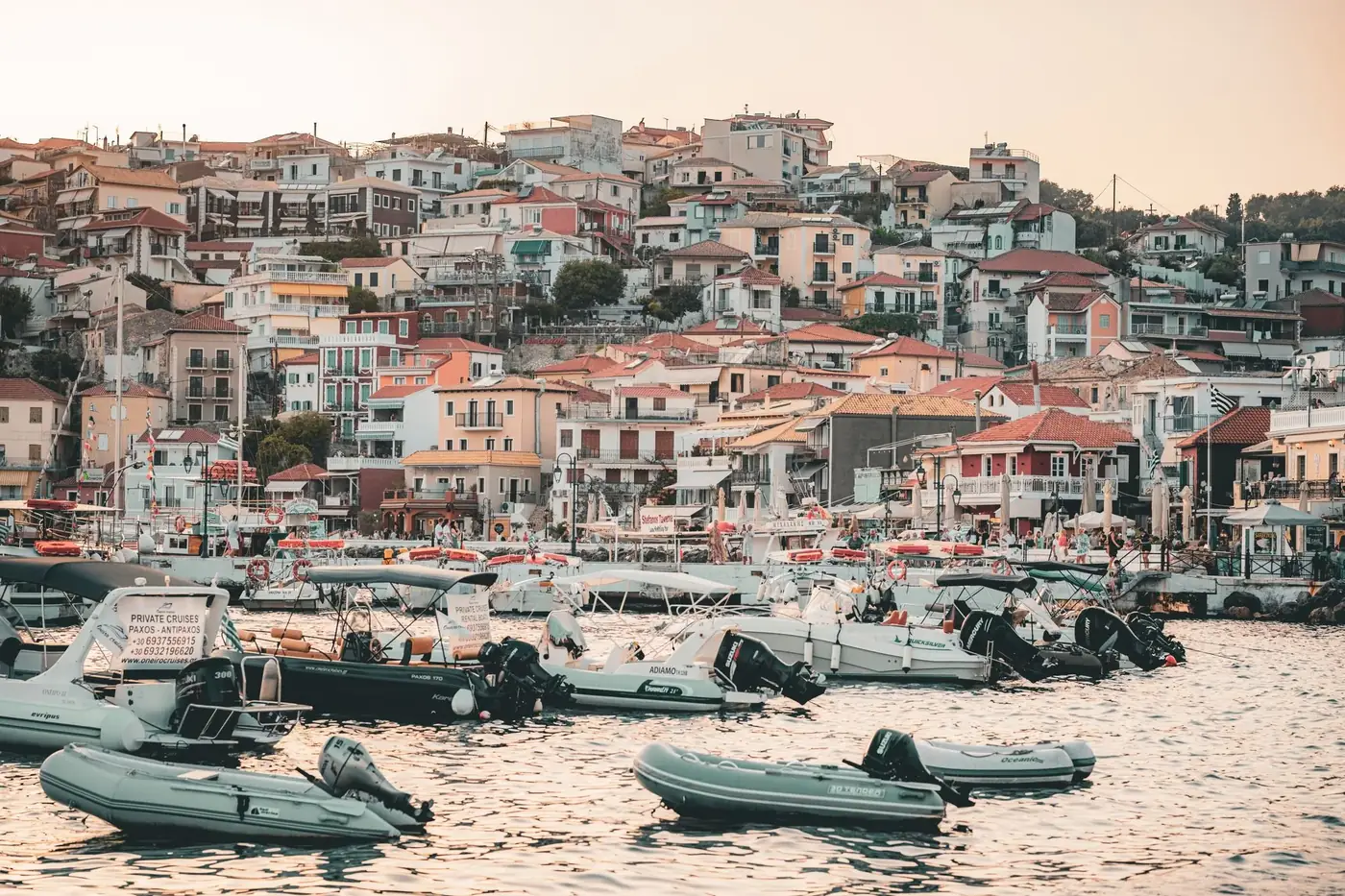 Explore picturesque Parga, Greece, with its colorful hillside houses and vibrant harbor filled with boats.
