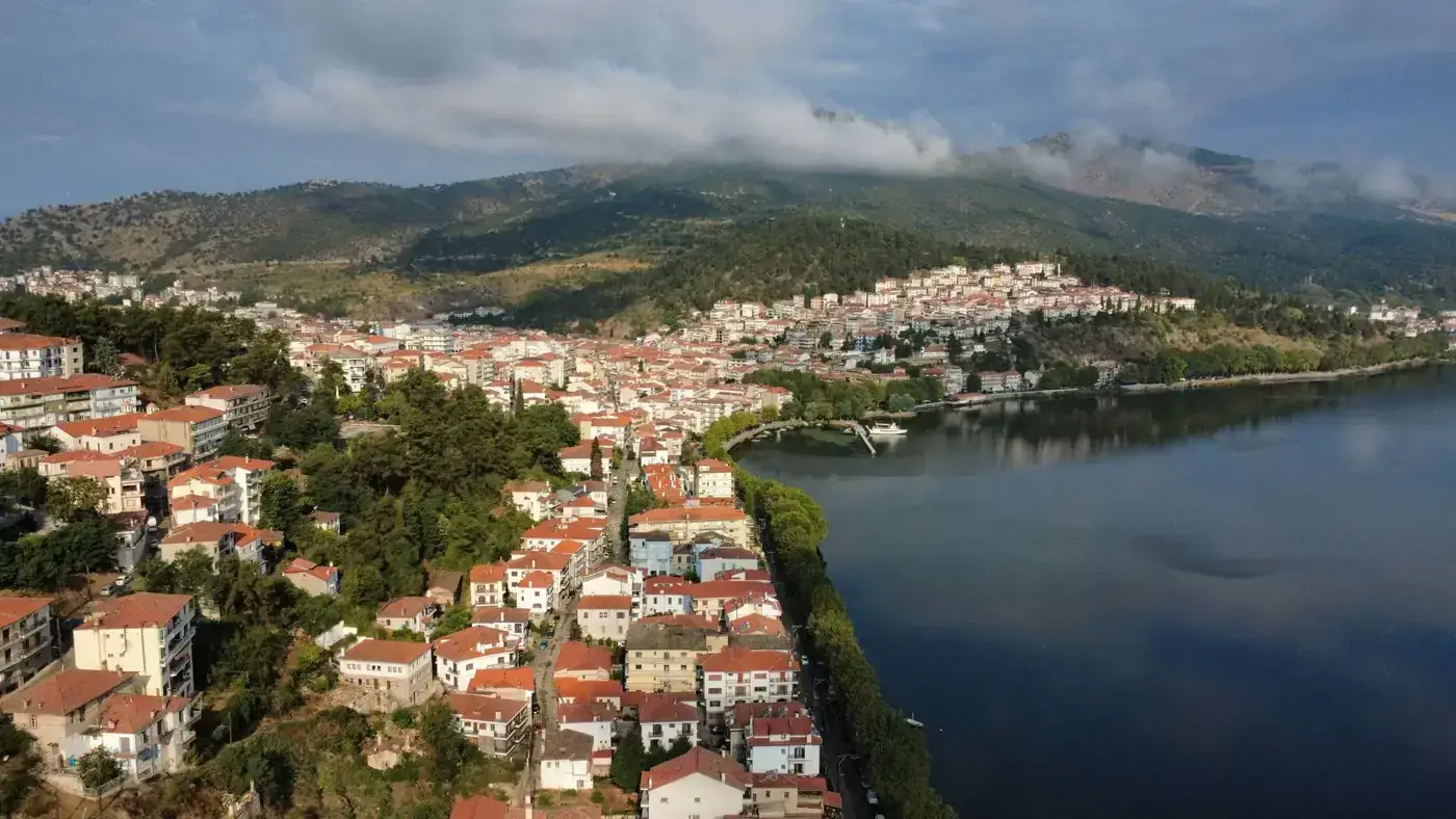 Stunning aerial view of Kastoria, Greece, showcasing its charming lakeside setting in a mountainous landscape.