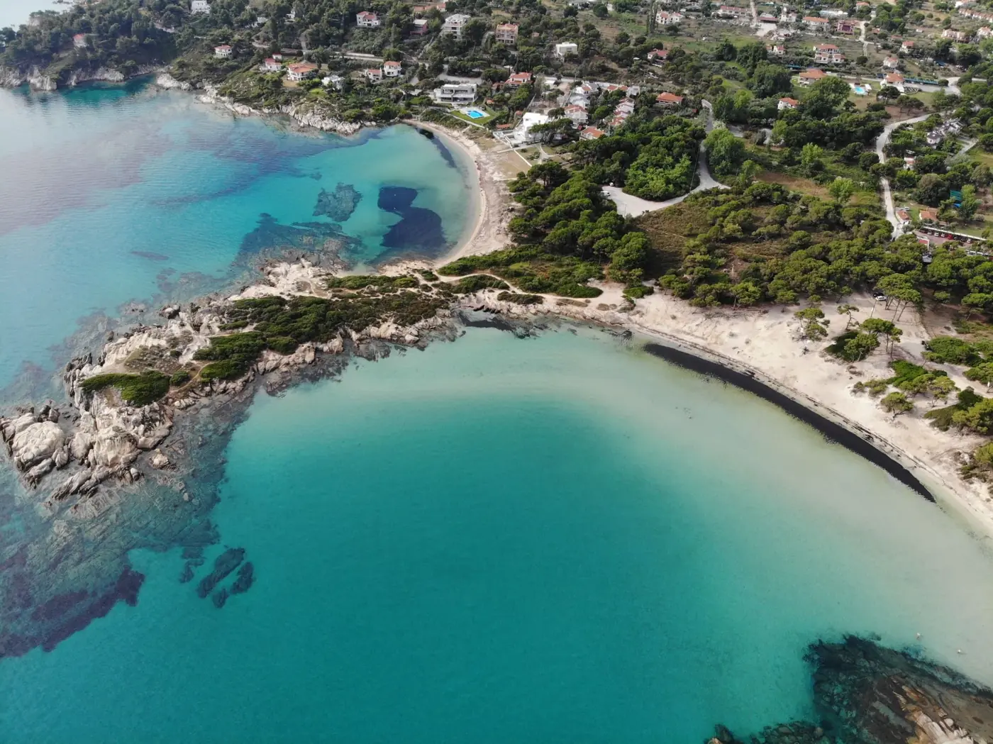 Discover the stunning beaches and vibrant sea of Sithonia, Halkidiki, Greece from above.