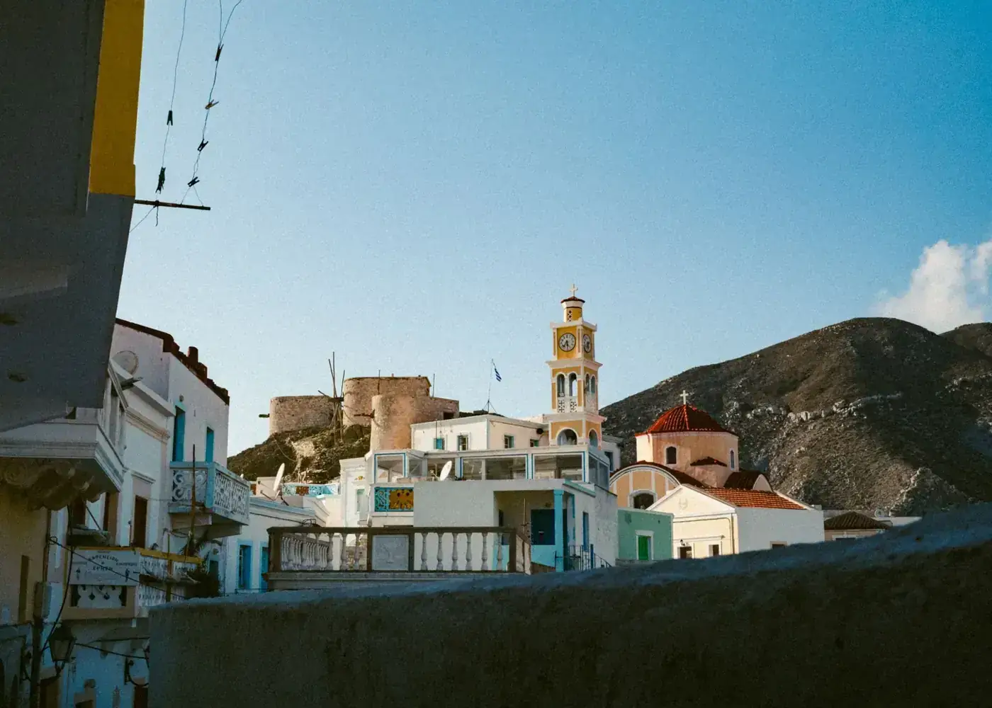 Charming scene of Olympos village, Greece, featuring traditional architecture and mountainous backdrop.