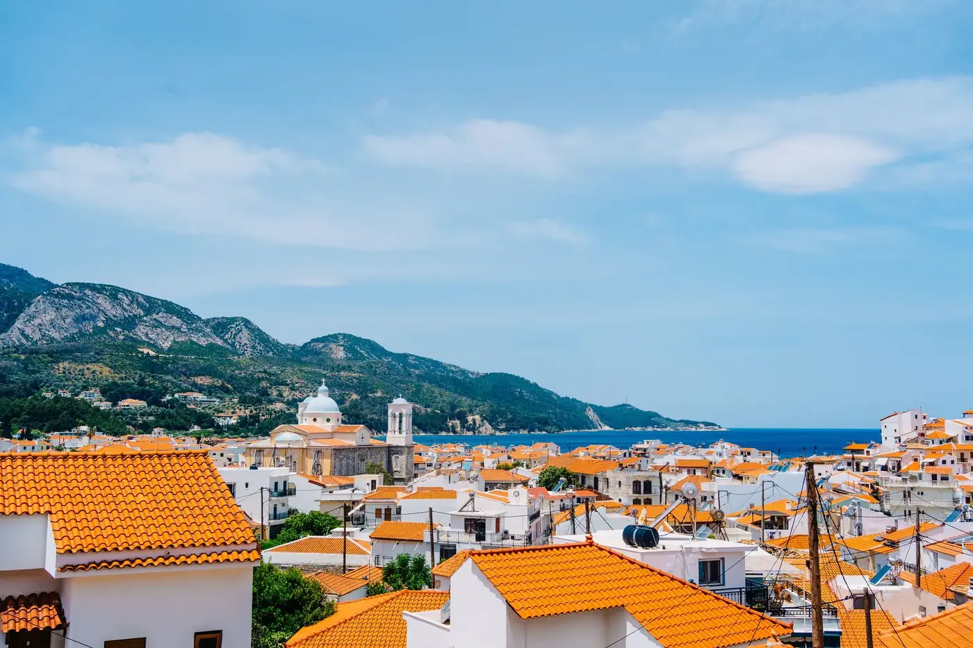 Panoramic view of Kokkari village with orange roofs by the sea in Greece.