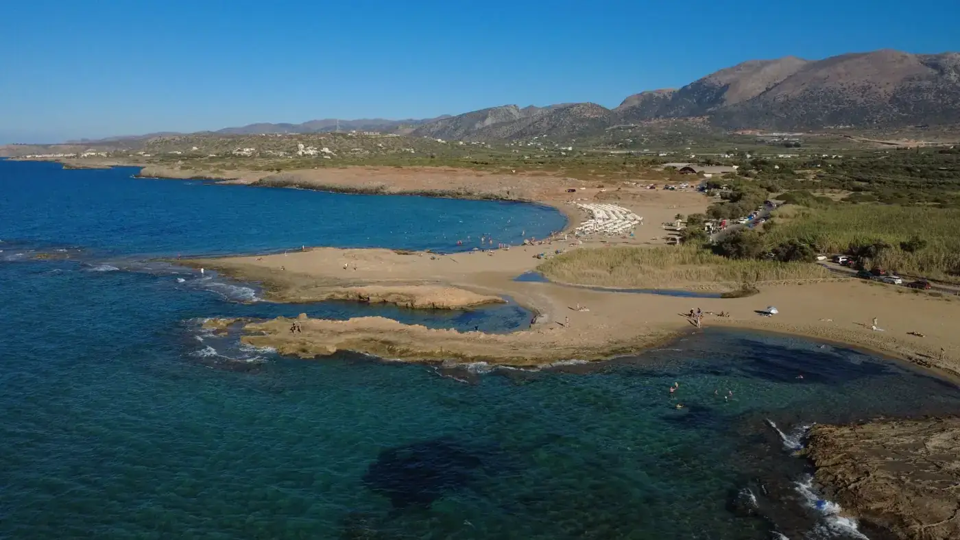 Aerial shot of Malia Beach in Greece showcasing clear waters and scenic coastline.