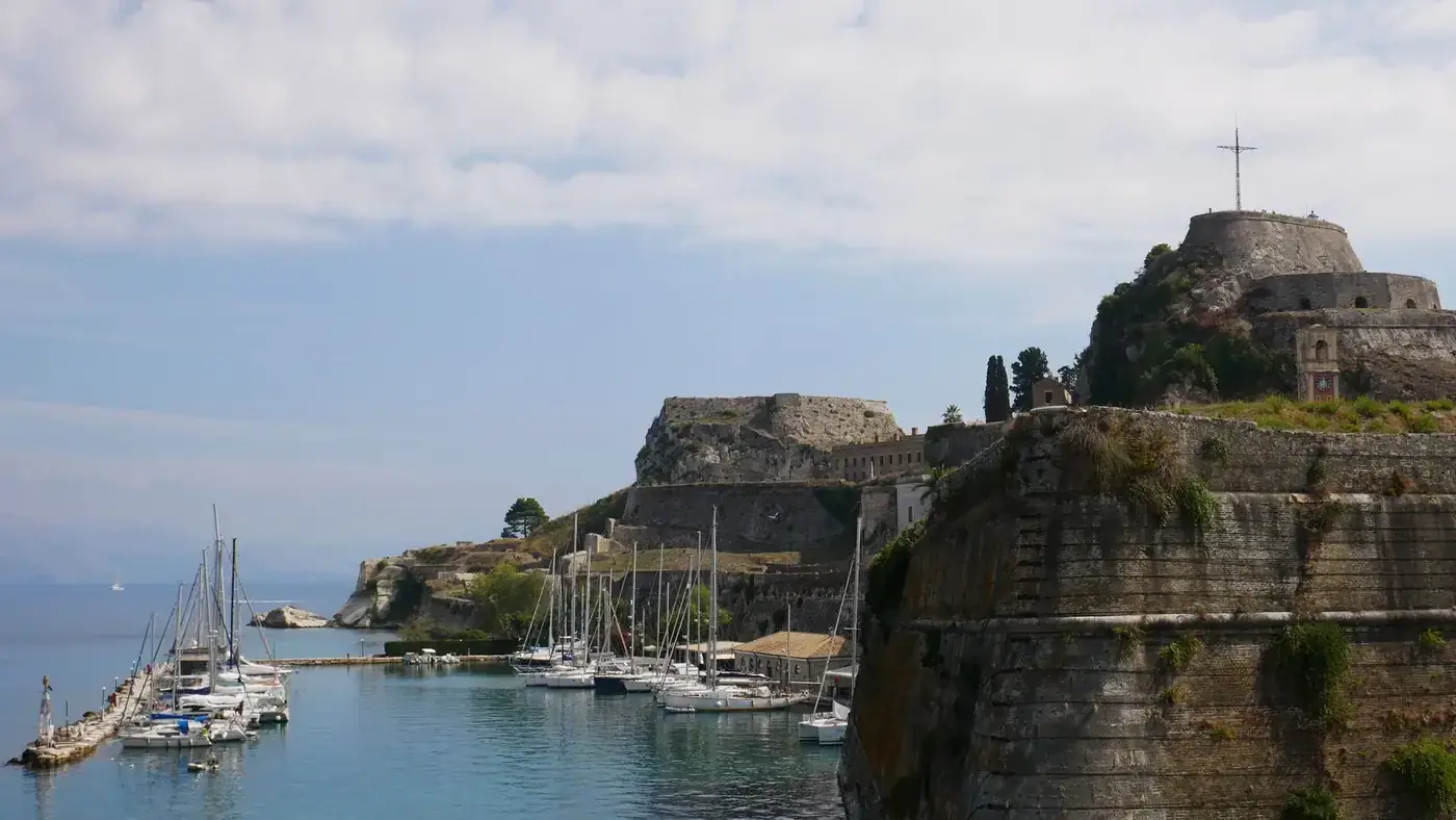 Discover the historic marina by Corfu's Old Fortress showcasing stunning architecture and sea views.
