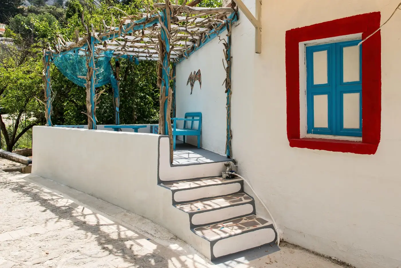 Explore the picturesque Greek architecture and vibrant colors of a traditional home in Kos, Greece.