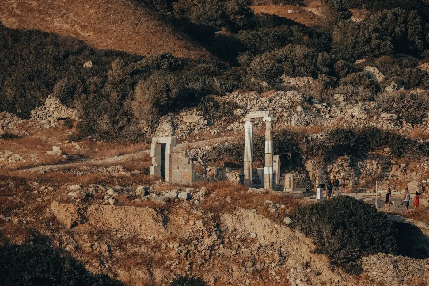 Explore ancient ruins surrounded by scenic landscapes in Greece, captured at golden hour.