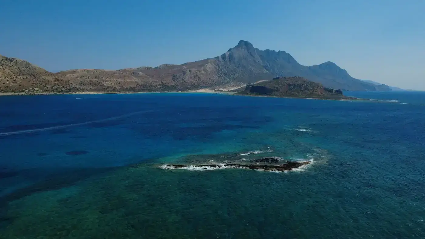 A breathtaking aerial view of the vibrant blue waters of Balos Lagoon in Crete, Greece.
