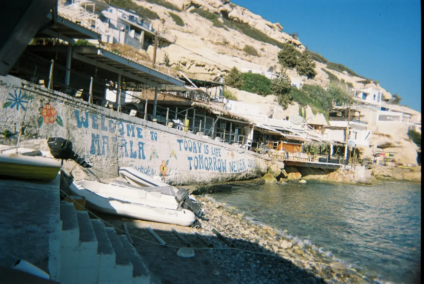 Charming coastal scene of Matala with rustic architecture along the shore.