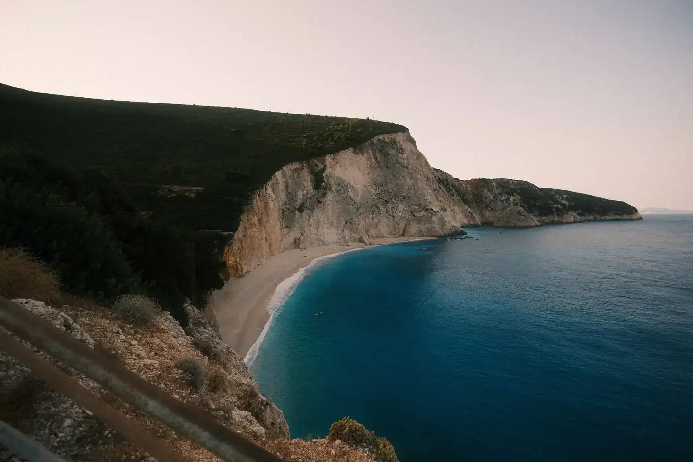 Experience the serene beauty of Porto Katsiki's cliffs and beaches at twilight in Lefkada, Greece.
