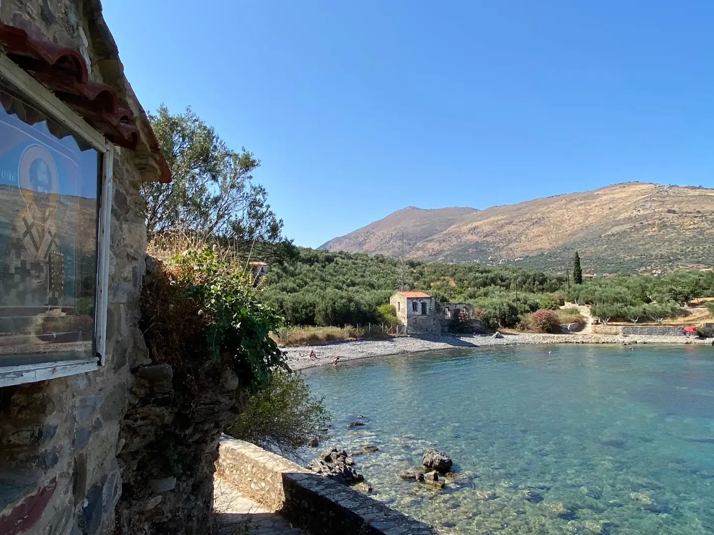 Beautiful coastal landscape of Kardamili with clear blue water and stone houses.
