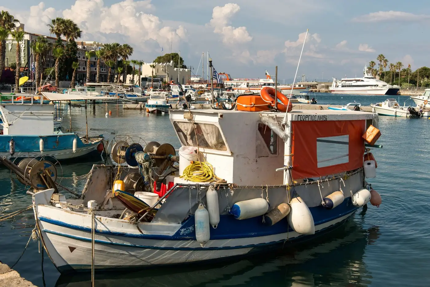 Idyllic view of fishing boats in Kos harbour, Greece, capturing the essence of Mediterranean charm.