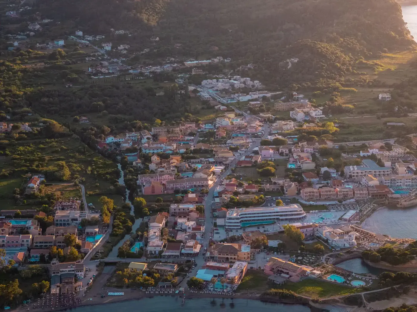 Stunning aerial view of Agios Georgios in Corfu, Greece, captured during sunset highlighting the vibrant architecture.