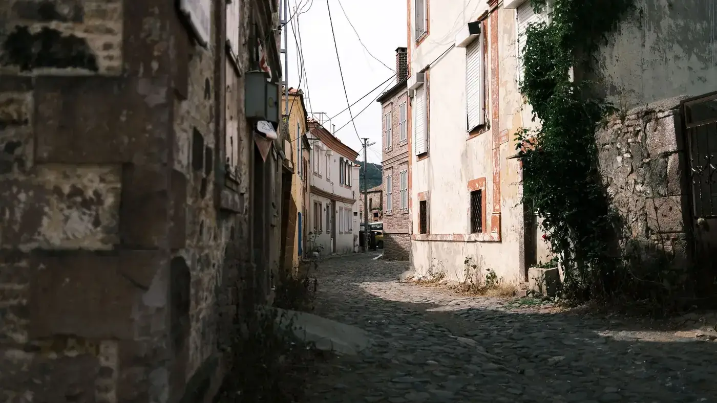 Charming cobblestone alley surrounded by rustic buildings in a historic old town setting.