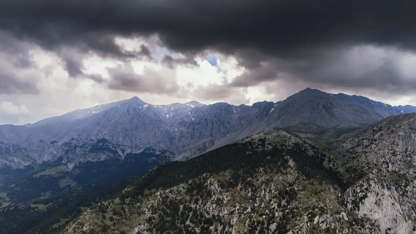 Majestic mountains under moody skies at Delphi, Greece, showcasing natural beauty and wilderness.