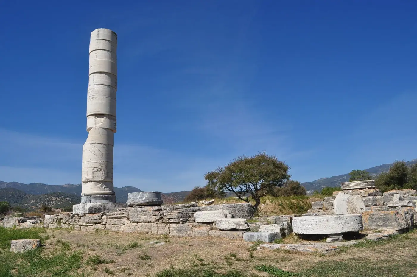 Explore the ancient ruins of Heraion under a clear blue sky in Samos, Greece.