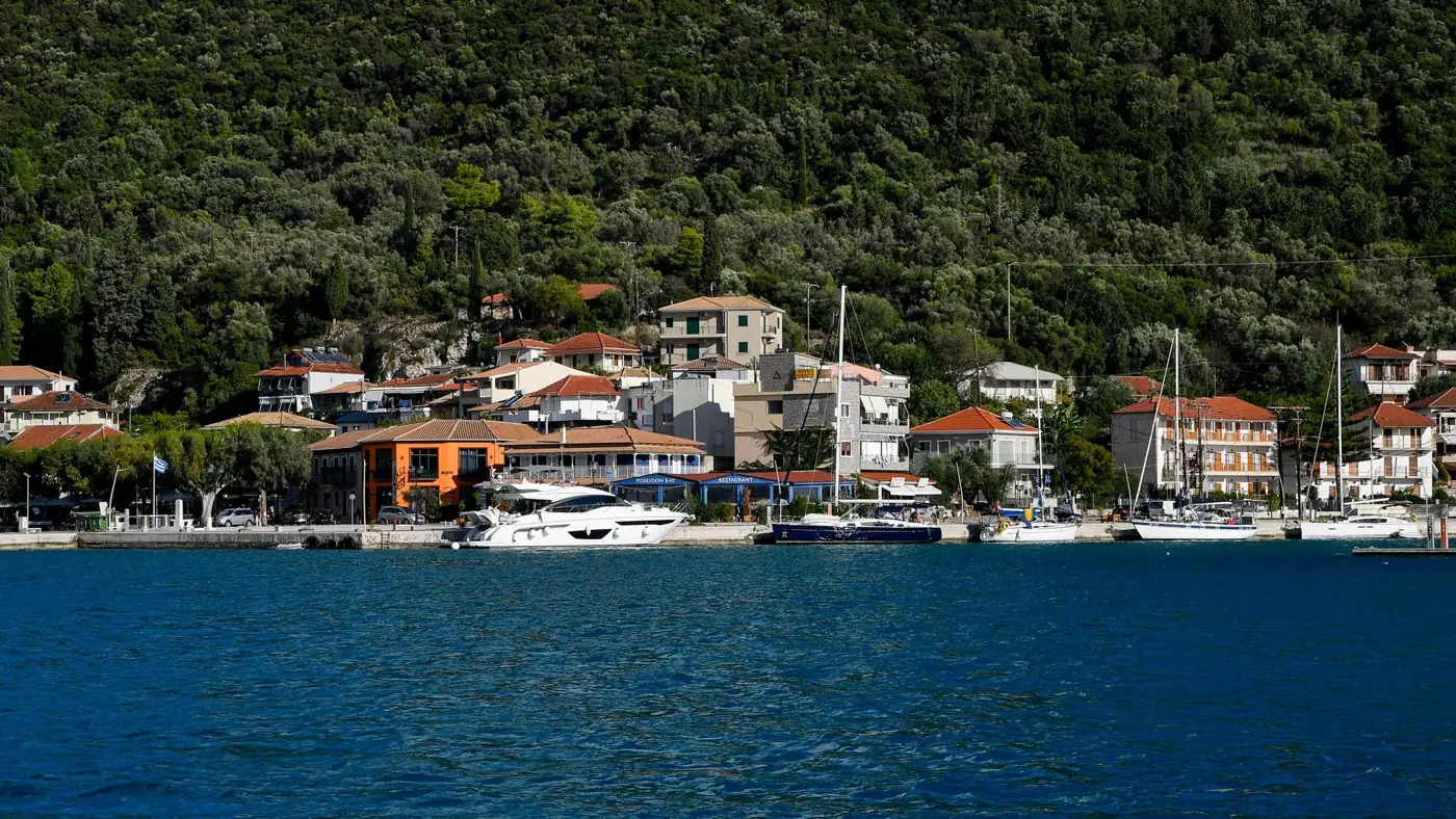 Picturesque coastal village with yachts in Patra, Greece, exemplifying Mediterranean charm.