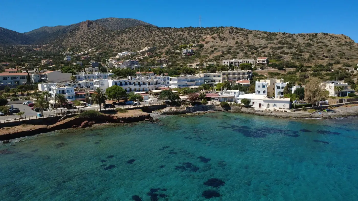 Stunning aerial view of the turquoise coastline and resort buildings in Stalida, Crete.