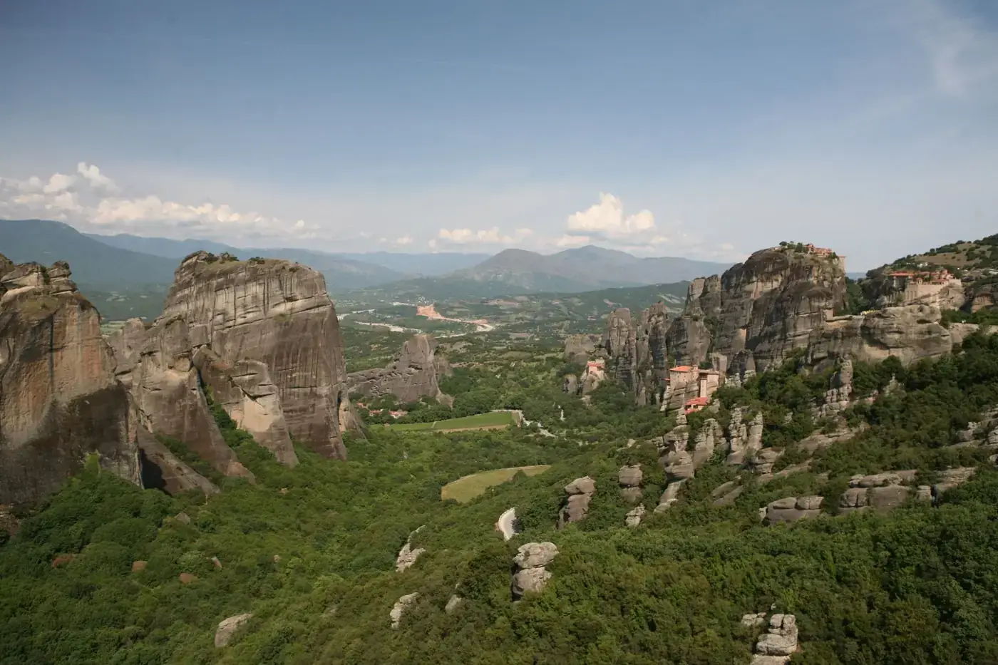 Explore the breathtaking rock formations of Meteora, Greece captured in summer's daylight.